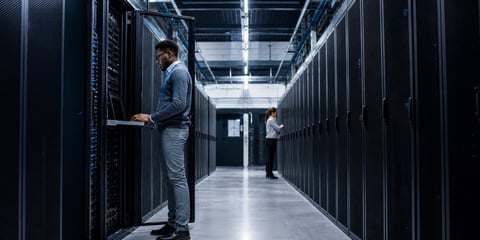 IT consultant reviewing configuration data in a server room, illustrating the 3 Cs of CMDB data quality