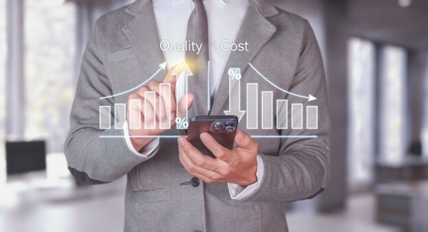 A business professional analysing quality and cost data on a phone, looking at IT cost optimization strategies.