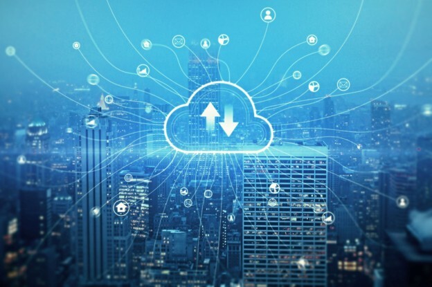 A Cloud computing network over a city skyline, representing cloud cost optimisation and reduced cloud spend. 