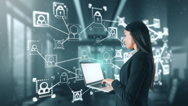 A female business professional using a laptop with connected system icons and security overlays, representing ServiceNow integration.
